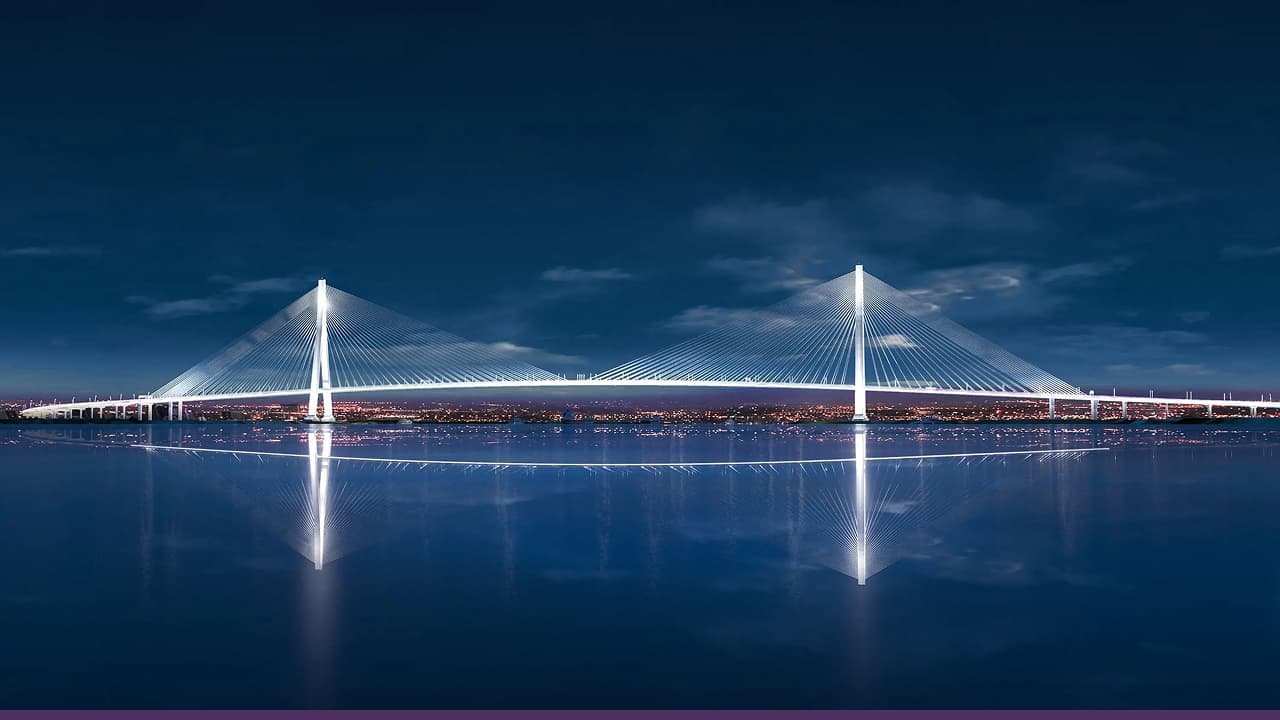 Gordie Howe International Bridge illuminated at night over rive