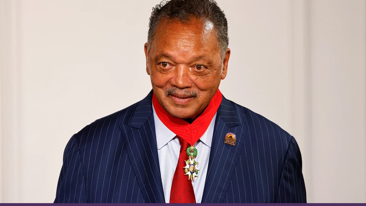 Reverend Jesse Jackson wearing medal and red tie