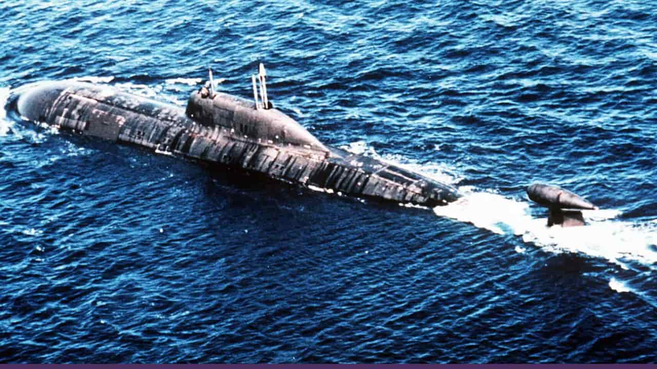 A military submarine cruising on the ocean surface, highlighting naval surveillance and undersea security operations.