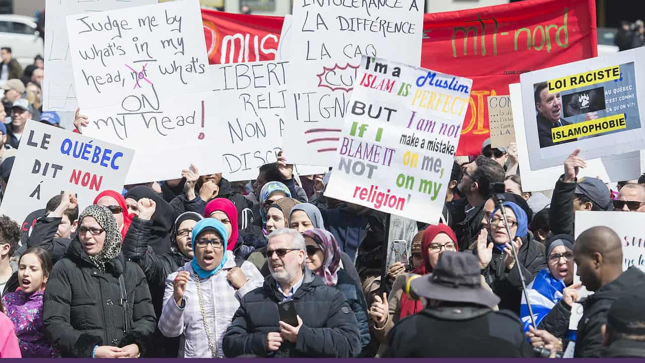 A voter casts a ballot at a polling station during a civic election, reflecting democratic participation amid political debates on secularism.